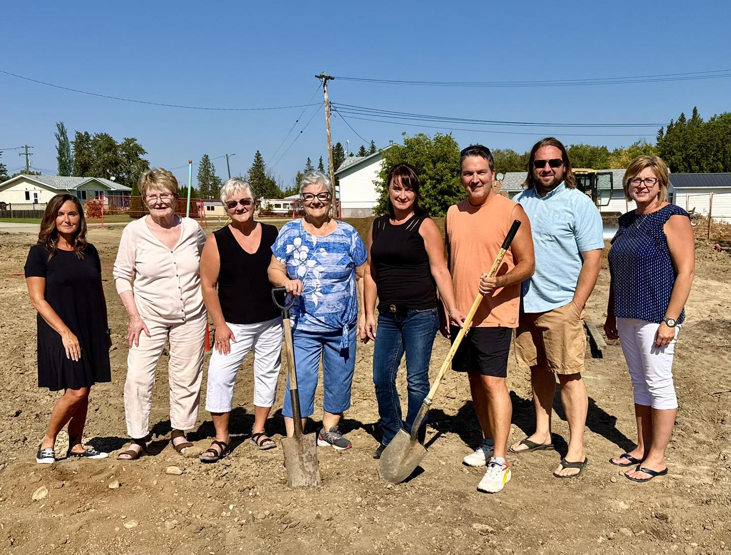 The Glendon and District Historical Society team pose with shovels for a ground breaking photo on a dirt lot